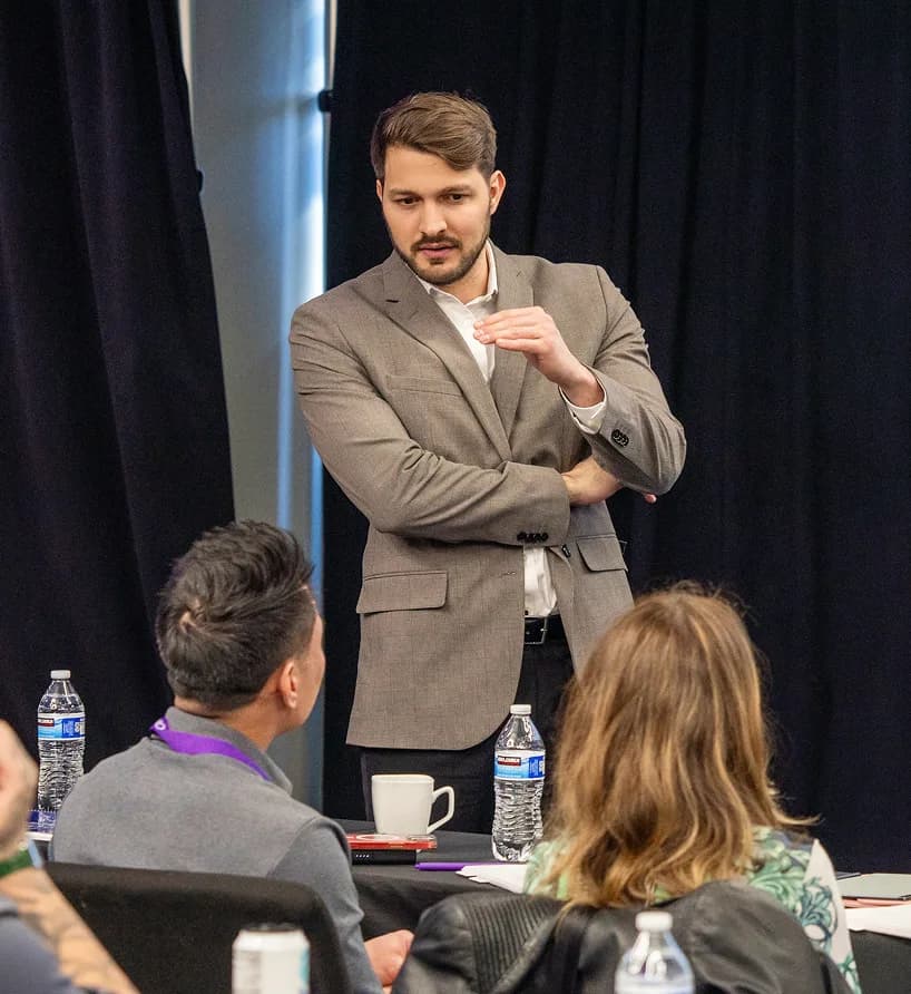 Lewis consulting founders on stage at a live scaling workshop